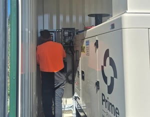 Prime technician working on water treatment monitoring and control equipment at O2NL site