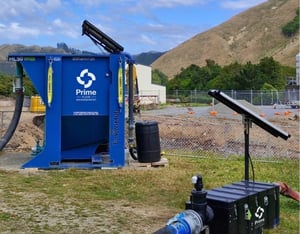 Solar-powered water quality monitoring unit beside a Prime water treatment setup