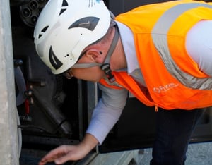 Prime technician inspecting water treatment equipment on site